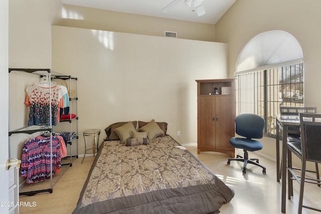 bedroom featuring ceiling fan, light wood-type flooring, multiple windows, and a high ceiling