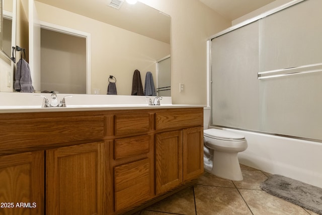 full bathroom featuring tile patterned floors, shower / bath combination with glass door, vanity, and toilet