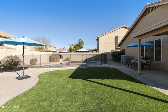 view of yard with central air condition unit, a patio area, and a pool