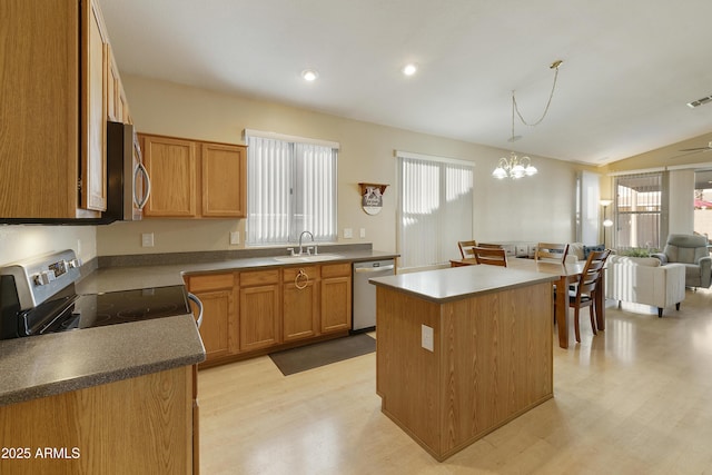 kitchen featuring light hardwood / wood-style floors, stainless steel appliances, pendant lighting, a kitchen island, and sink