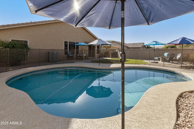 view of swimming pool with a patio area and central air condition unit