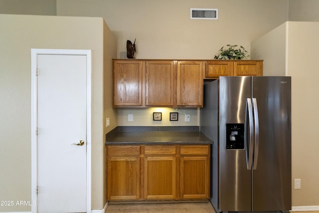 kitchen featuring stainless steel refrigerator with ice dispenser