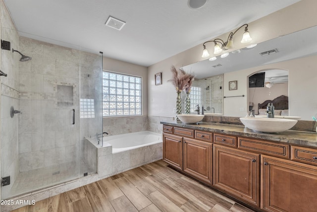full bath with a bath, visible vents, and a sink