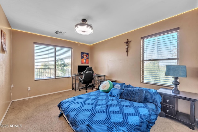 bedroom featuring visible vents, light carpet, and baseboards