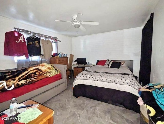 bedroom featuring ceiling fan and concrete floors