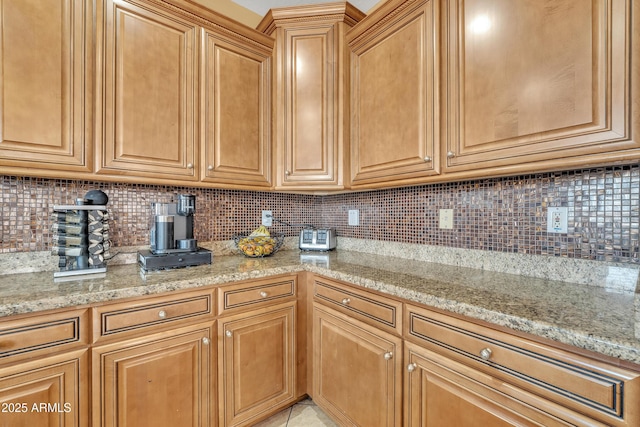 kitchen featuring light stone counters and decorative backsplash