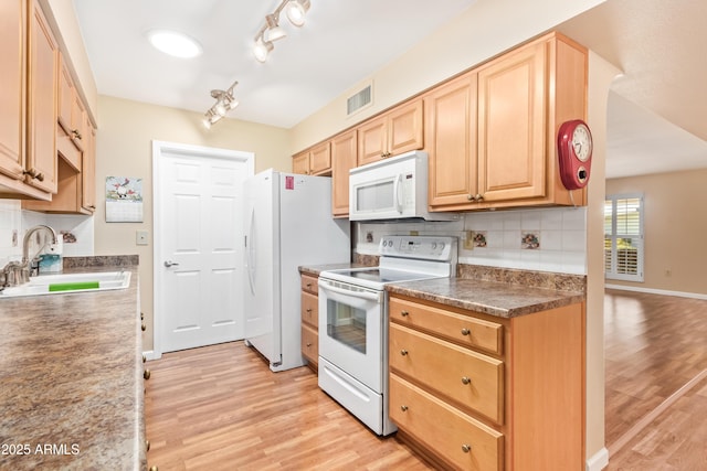 kitchen featuring light brown cabinetry, sink, tasteful backsplash, light hardwood / wood-style flooring, and white appliances