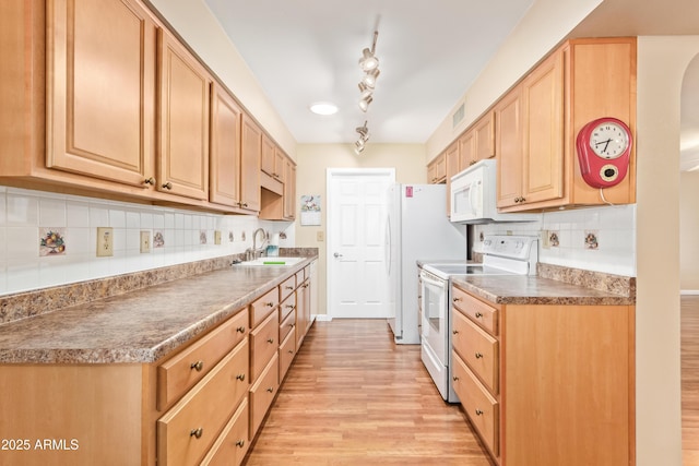 kitchen featuring light brown cabinetry, sink, light wood-type flooring, white appliances, and decorative backsplash