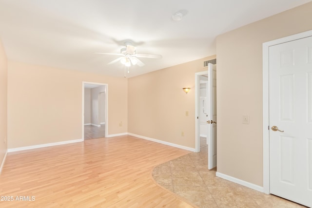 empty room with light hardwood / wood-style floors and ceiling fan