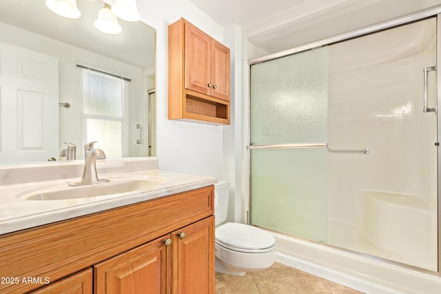 bathroom featuring an enclosed shower, vanity, tile patterned flooring, and toilet