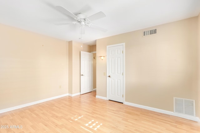 empty room with light hardwood / wood-style floors and ceiling fan