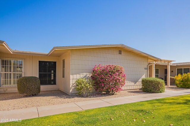 view of property exterior featuring a lawn