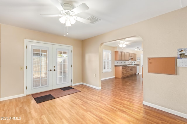 doorway to outside with light hardwood / wood-style floors, french doors, and ceiling fan