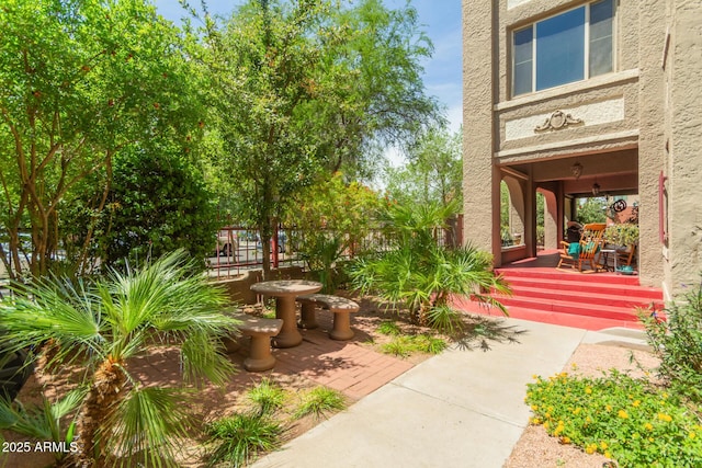 view of yard with a porch and fence
