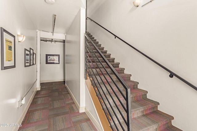 staircase featuring baseboards