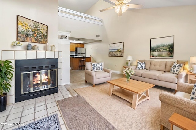 tiled living room featuring high vaulted ceiling and ceiling fan