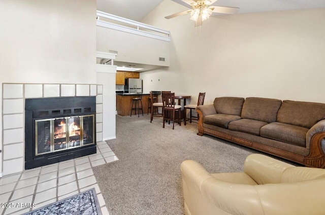 tiled living room with ceiling fan and high vaulted ceiling