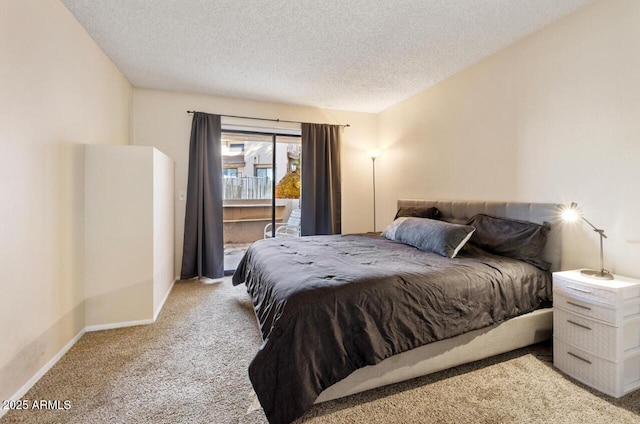 carpeted bedroom with access to outside and a textured ceiling