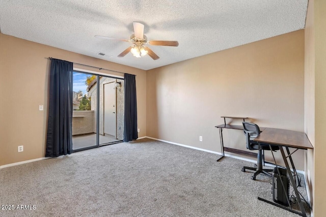 carpeted office featuring a textured ceiling and ceiling fan