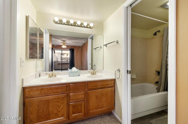 bathroom featuring ceiling fan, vanity, and shower / bath combo