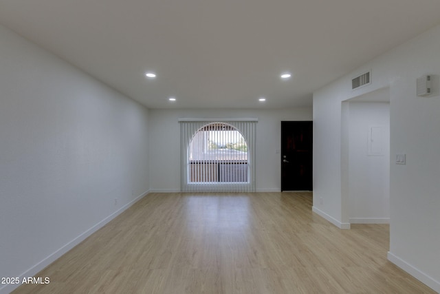 spare room with light wood-style flooring, recessed lighting, and baseboards