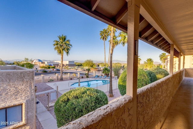 view of patio featuring a community pool and fence