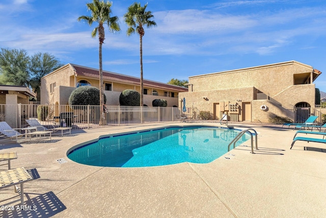 community pool featuring a patio and fence