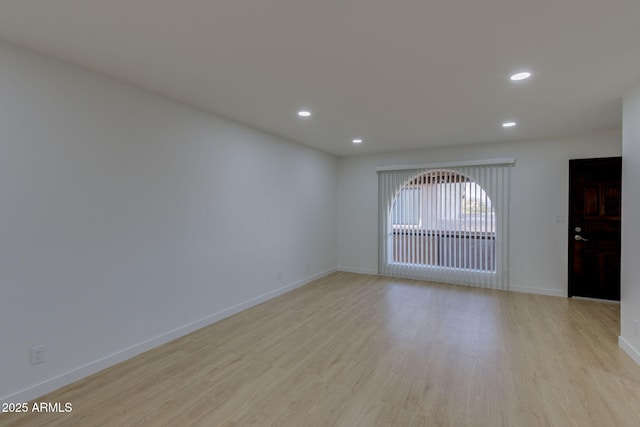empty room featuring light wood-type flooring, recessed lighting, and baseboards