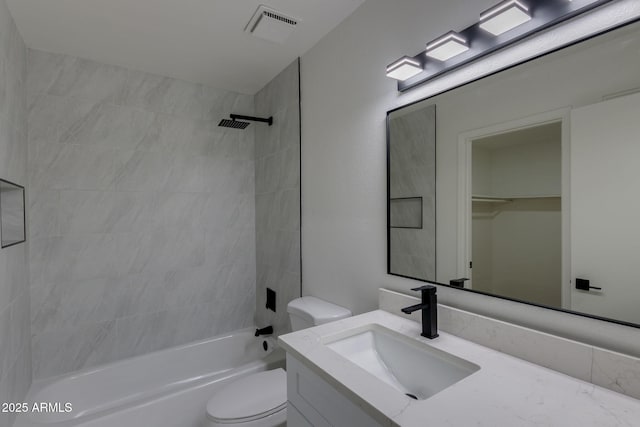 bathroom featuring toilet, bathtub / shower combination, and vanity