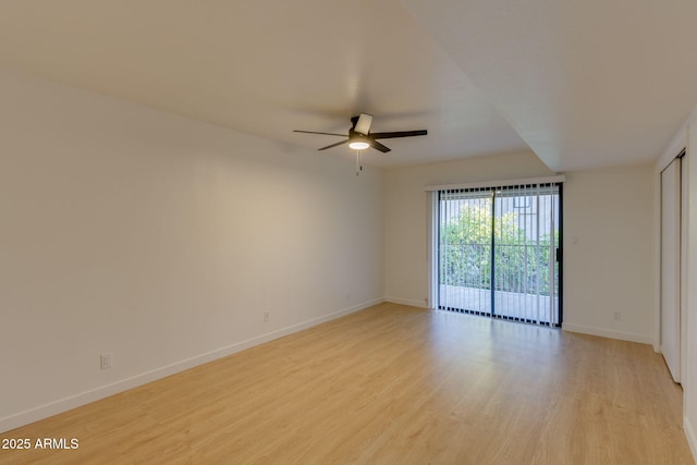 unfurnished room featuring ceiling fan, light wood-type flooring, and baseboards