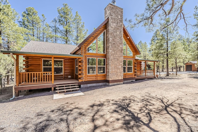 2793 Canyon Ridge Rd, Overgaard, AZ 85933 - back of house with a wooden deck, a chimney, log siding, and roof with shingles