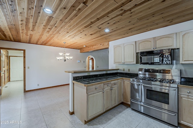 2793 Canyon Ridge Rd, Overgaard, AZ 85933 - kitchen with a peninsula, a notable chandelier, range with two ovens, black microwave, and tile countertops