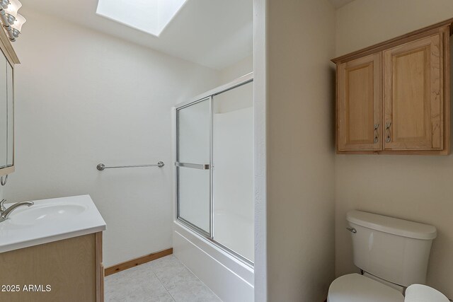 2793 Canyon Ridge Rd, Overgaard, AZ 85933 - bathroom featuring a skylight, vanity, bath / shower combo with glass door, toilet, and tile patterned flooring