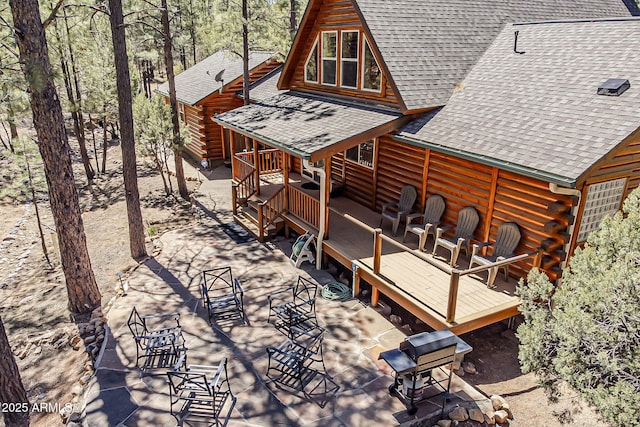 2793 Canyon Ridge Rd, Overgaard, AZ 85933 - exterior space featuring log exterior, a shingled roof, and a deck