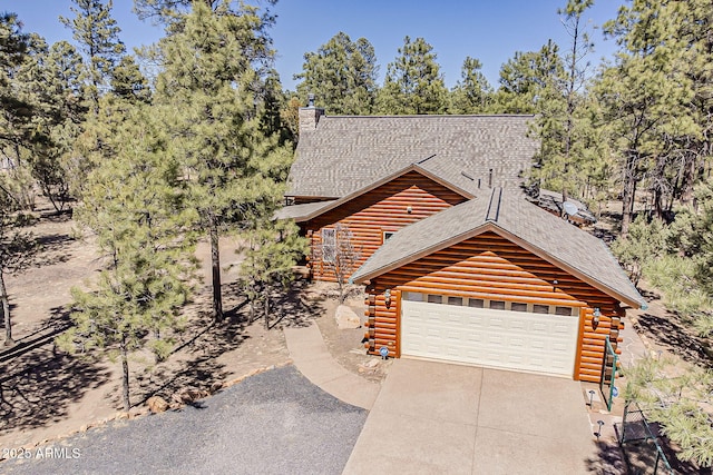 2793 Canyon Ridge Rd, Overgaard, AZ 85933 - log home featuring a garage, log exterior, roof with shingles, and concrete driveway