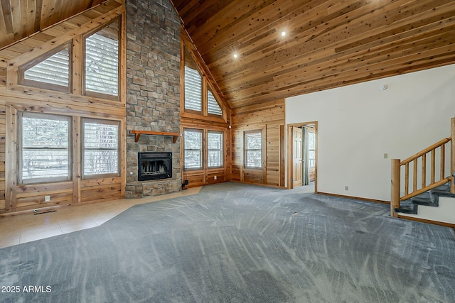 2793 Canyon Ridge Rd, Overgaard, AZ 85933 - unfurnished living room with stairway, wood walls, wood ceiling, a fireplace, and high vaulted ceiling
