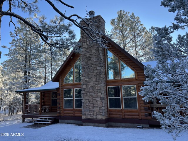 2793 Canyon Ridge Rd, Overgaard, AZ 85933 - back of property with fence, a chimney, log siding, and a deck
