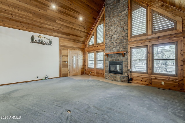 2793 Canyon Ridge Rd, Overgaard, AZ 85933 - unfurnished living room featuring wooden walls, a stone fireplace, wooden ceiling, carpet floors, and high vaulted ceiling