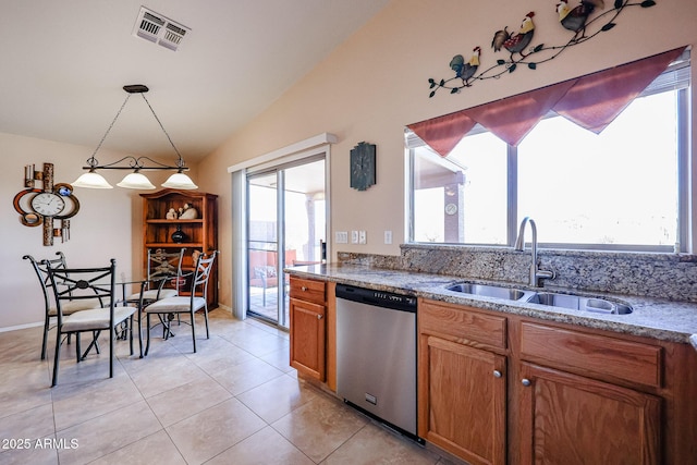 kitchen with sink, light tile patterned floors, hanging light fixtures, vaulted ceiling, and stainless steel dishwasher