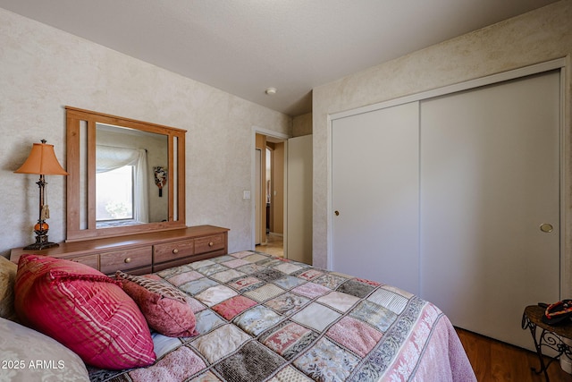 bedroom featuring wood-type flooring and a closet