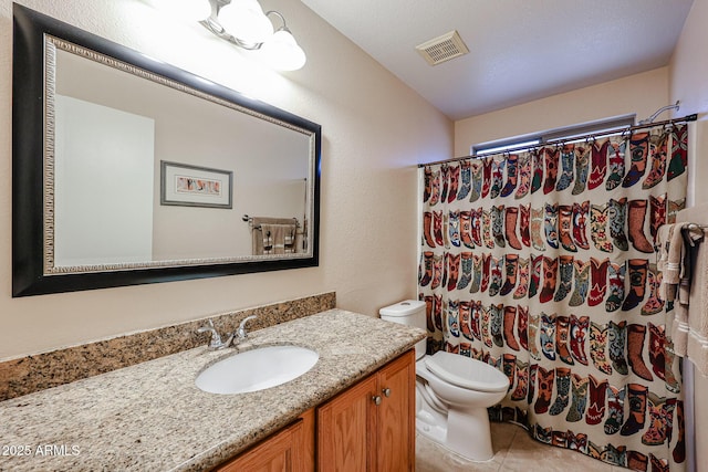 bathroom featuring vanity, tile patterned flooring, curtained shower, and toilet