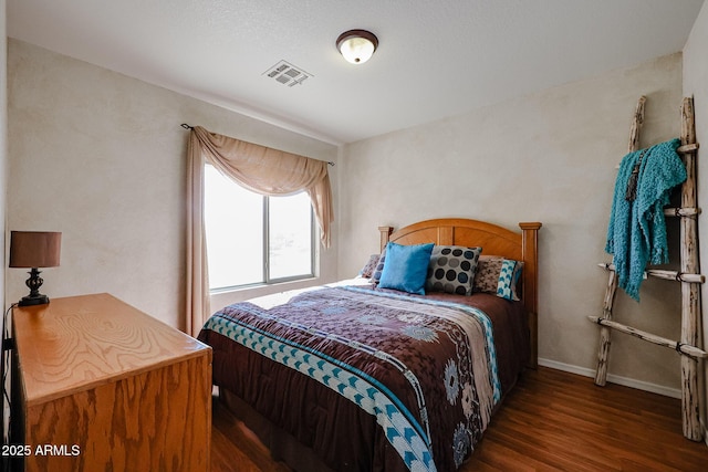 bedroom with dark hardwood / wood-style flooring