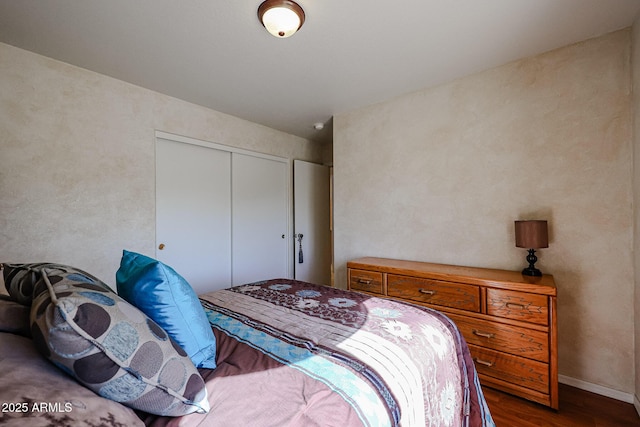 bedroom featuring hardwood / wood-style flooring and a closet