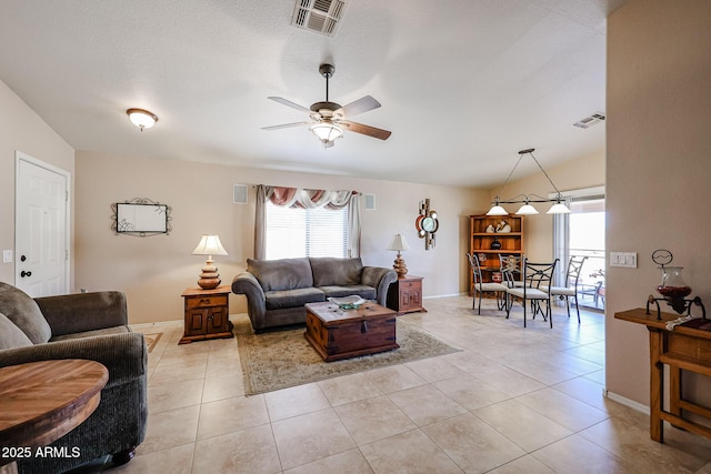 tiled living room featuring ceiling fan