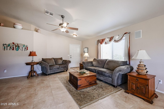 living room featuring lofted ceiling, light tile patterned floors, and ceiling fan