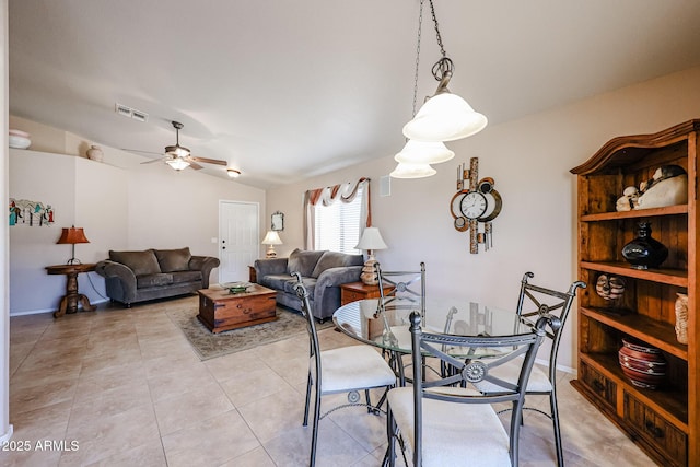 dining space with light tile patterned flooring, ceiling fan, and lofted ceiling