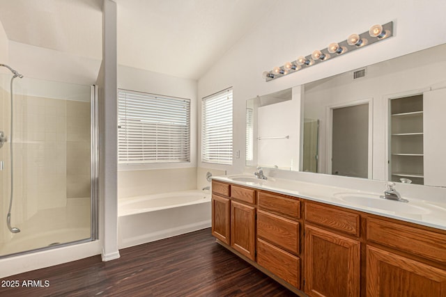 full bath with a stall shower, visible vents, a sink, and a bath
