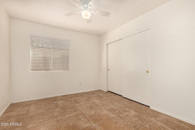 unfurnished bedroom featuring baseboards, a closet, and ceiling fan