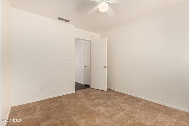unfurnished room with a ceiling fan, baseboards, and visible vents