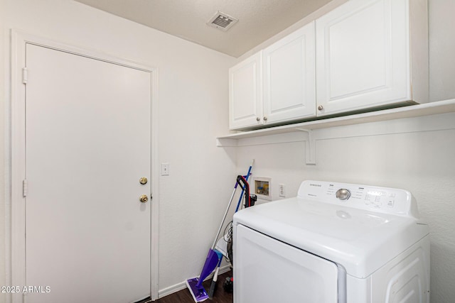 laundry room with dark wood finished floors, visible vents, washer / clothes dryer, and cabinet space